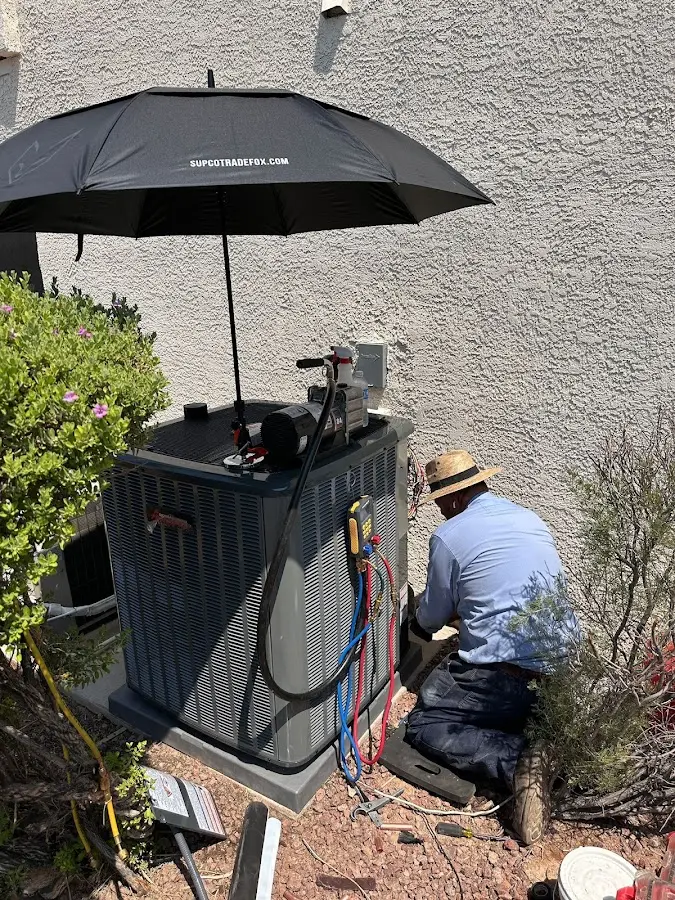 HVAC technician performing outdoor AC maintenance in Glenn Heights